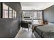 Inviting bedroom features a chair, wall art, a sleek desk, and plenty of natural light at 1050 N Corona St # 206, Denver, CO 80218