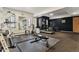Spacious gym with treadmill, bike, weights, and mirrored wall for home fitness at 1050 N Corona St # 206, Denver, CO 80218