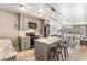 A well-lit kitchen with grey cabinets, black appliances, marble island and hardwood floors at 1050 N Corona St # 206, Denver, CO 80218