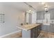 Bright kitchen features white subway tile, modern gray cabinetry, and an island with seating at 1050 N Corona St # 206, Denver, CO 80218