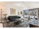 Comfortable living room featuring stylish decor, natural light, and a cozy sofa at 1050 N Corona St # 206, Denver, CO 80218