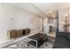 Inviting open-concept living area with modern furniture flows into the kitchen at 1050 N Corona St # 206, Denver, CO 80218