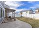 This backyard features a comfortable patio swing, a lawn, and a white fence at 5017 Ceylon St, Denver, CO 80249