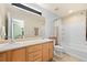 Bathroom featuring double sinks, a large mirror, and a shower and tub combo at 5017 Ceylon St, Denver, CO 80249