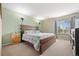 Bedroom featuring a large bed, side tables, and natural light from the window at 5017 Ceylon St, Denver, CO 80249