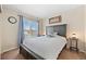 Bedroom featuring a large bed, side tables, and a window with natural light at 5017 Ceylon St, Denver, CO 80249