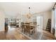 Dining area with a rustic wooden table and chairs, complemented by a modern chandelier at 5017 Ceylon St, Denver, CO 80249