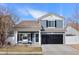 Charming two-story home with well-maintained landscaping, covered porch, and two car garage at 5017 Ceylon St, Denver, CO 80249