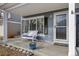 Cozy front porch with a bench, decorative pot, and a view of the home's entrance at 5017 Ceylon St, Denver, CO 80249