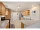 Kitchen with light wood cabinetry, stainless steel appliances, and laminate countertops at 5017 Ceylon St, Denver, CO 80249