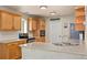 Well-lit kitchen featuring light wood cabinetry, stainless steel appliances, and a spacious countertop at 5017 Ceylon St, Denver, CO 80249