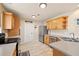 Bright kitchen with wood cabinets, stainless steel refrigerator, and tile flooring at 5017 Ceylon St, Denver, CO 80249