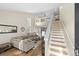 Bright living room featuring hardwood floors, a comfortable sectional sofa, and staircase to a loft at 5017 Ceylon St, Denver, CO 80249