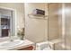 Bright bathroom featuring a sink, a toilet, a shower with glass door and a stack of clean, gray towels at 3125 Starling Ct, Castle Rock, CO 80109