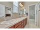 Bright bathroom featuring double sinks, modern lighting, and tile flooring at 3125 Starling Ct, Castle Rock, CO 80109