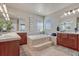 Bathroom with double sink vanity, soaking tub, and tiled floors, perfect for relaxation and comfort at 3125 Starling Ct, Castle Rock, CO 80109