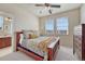 Cozy bedroom with a decorative bed, ceiling fan, and two sunny windows at 3125 Starling Ct, Castle Rock, CO 80109