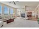 Bright living room with fireplace, large windows, and access to the kitchen and dining area at 3125 Starling Ct, Castle Rock, CO 80109
