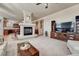 Spacious living room featuring a fireplace and open layout with seamless transition to kitchen at 3125 Starling Ct, Castle Rock, CO 80109