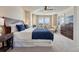 Bright main bedroom featuring a large bed, dresser, and windows with scenic views of the neighborhood at 3125 Starling Ct, Castle Rock, CO 80109