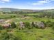 Aerial view of property showcasing stunning landscape, mature trees, and golf course at 5979 Willow Springs Dr, Morrison, CO 80465
