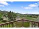 Picturesque view from the deck of rolling hills, mature trees, and horse pasture at 5979 Willow Springs Dr, Morrison, CO 80465