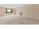Spacious carpeted basement with bay windows and an exterior door at 5979 Willow Springs Dr, Morrison, CO 80465