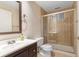 Neutral-toned bathroom featuring a glass shower, vanity and mirror, and a toilet at 5979 Willow Springs Dr, Morrison, CO 80465