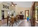 Inviting dining area with a wooden table, surrounded by a well-lit space and doors leading to the outdoors at 5979 Willow Springs Dr, Morrison, CO 80465