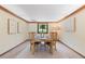 Traditional dining room featuring a wooden table set for four beneath a window with a view of the outdoors at 5979 Willow Springs Dr, Morrison, CO 80465