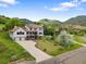 Stunning two-story home with a well-manicured lawn and a mountain backdrop at 5979 Willow Springs Dr, Morrison, CO 80465