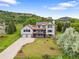 Beautiful two-story home featuring a deck and a sprawling landscaped yard at 5979 Willow Springs Dr, Morrison, CO 80465