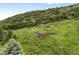 Picturesque gazebo nestled on a lush green hillside, providing a serene escape at 5979 Willow Springs Dr, Morrison, CO 80465