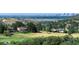 Expansive golf course view with city skyline in distance, showcasing a desirable community at 5979 Willow Springs Dr, Morrison, CO 80465