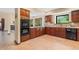Gourmet kitchen with wood cabinets, granite counters, tile floors, and modern appliances, offering both style and functionality at 5979 Willow Springs Dr, Morrison, CO 80465