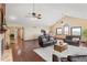 Spacious living room featuring hardwood floors, a comfortable seating arrangement, and an abundance of natural light at 5979 Willow Springs Dr, Morrison, CO 80465