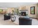 Comfortable living room featuring a fireplace, cozy seating, and sliding glass door to deck at 5979 Willow Springs Dr, Morrison, CO 80465