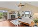 Bright main bedroom featuring a fireplace, bay windows, and vaulted ceiling, providing stunning views at 5979 Willow Springs Dr, Morrison, CO 80465