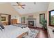 Spacious main bedroom with access to a balcony, fireplace, and beautiful outdoor scenery at 5979 Willow Springs Dr, Morrison, CO 80465