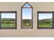 Scenic view from the windows of green hills, meadows, and scattered trees under a bright, clear blue sky at 5979 Willow Springs Dr, Morrison, CO 80465