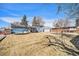 A large backyard with equipment, sheds, and fencing at 11744 W 71St Pl, Arvada, CO 80004
