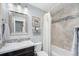 Well-maintained bathroom with earth tone tile surround and a vanity with a dark wood cabinet at 11744 W 71St Pl, Arvada, CO 80004