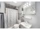 Compact bathroom featuring neutral walls, neutral flooring, and a combined shower and tub with a curtain at 11744 W 71St Pl, Arvada, CO 80004
