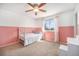 Bright bedroom with soft carpet, two-toned pink and white walls, and a decorative white bedframe at 11744 W 71St Pl, Arvada, CO 80004