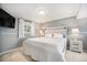 Cozy bedroom with neutral walls, plush carpet, and a comfortable queen-sized bed with stylish lamps at 11744 W 71St Pl, Arvada, CO 80004