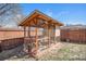 Backyard chicken coop with screen walls and a wooden frame provides a safe space for your hens at 11744 W 71St Pl, Arvada, CO 80004