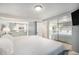 Serene main bedroom with a mirrored closet, neutral colors, and comfortable queen-sized bed at 11744 W 71St Pl, Arvada, CO 80004