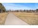 Peaceful park scene featuring a paved pathway and open grassy expanse, perfect for outdoor recreation at 11744 W 71St Pl, Arvada, CO 80004