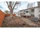 Spacious backyard featuring a patio and a large tree provides ample space at 4051 S Cherokee St, Englewood, CO 80110