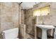 Tiled bathroom featuring a walk-in shower, pedestal sink, and toilet at 4051 S Cherokee St, Englewood, CO 80110
